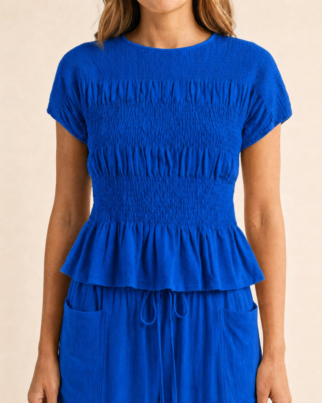 Smocked top and wide-leg pants set in blue, close-up of the smocked top