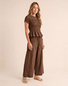 Smocked top and wide-leg pants set in brown, walking