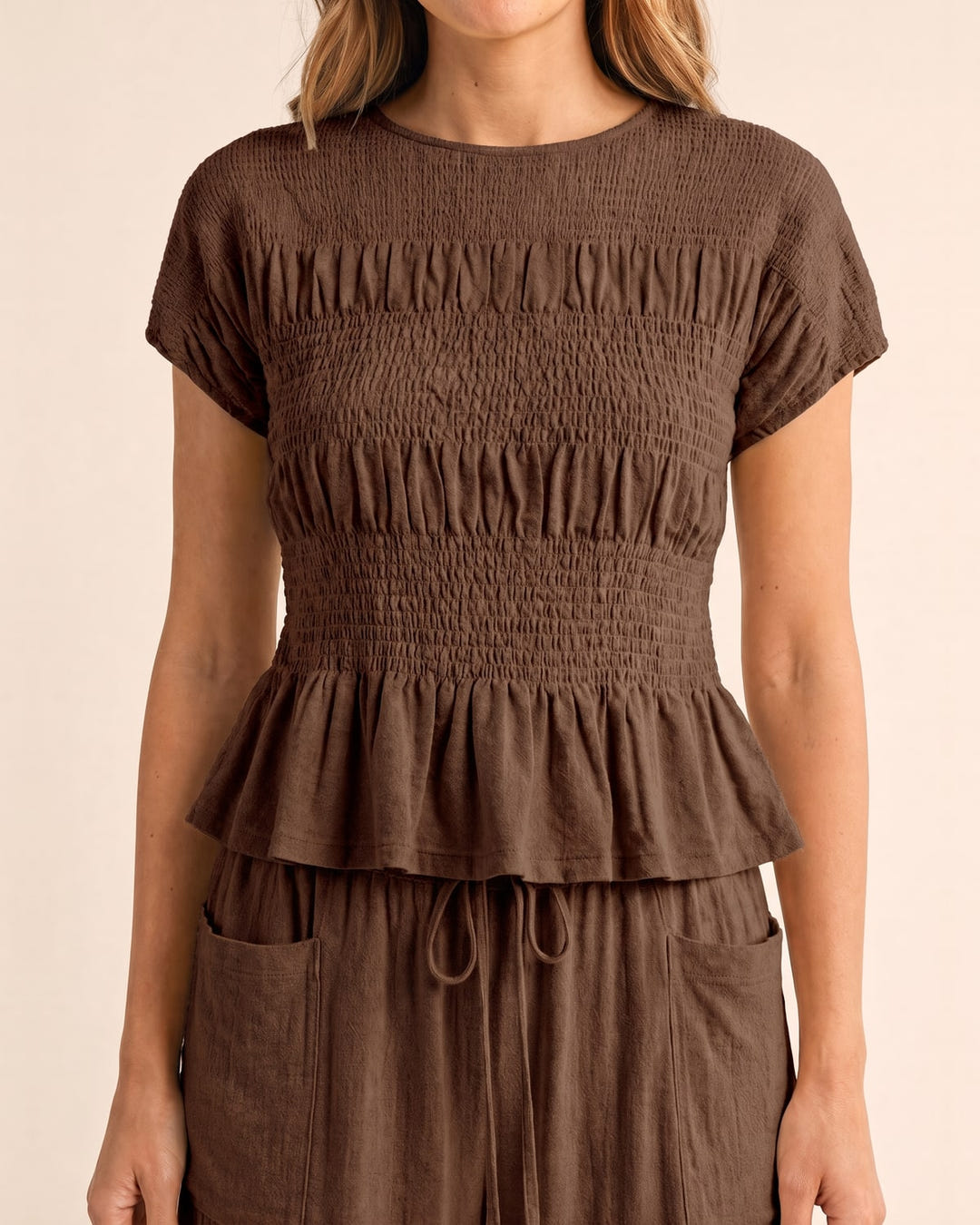 Smocked top and wide-leg pants set in brown, close-up of the smocked top