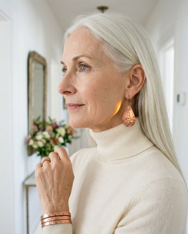 Woman wearing copper teardrop earrings