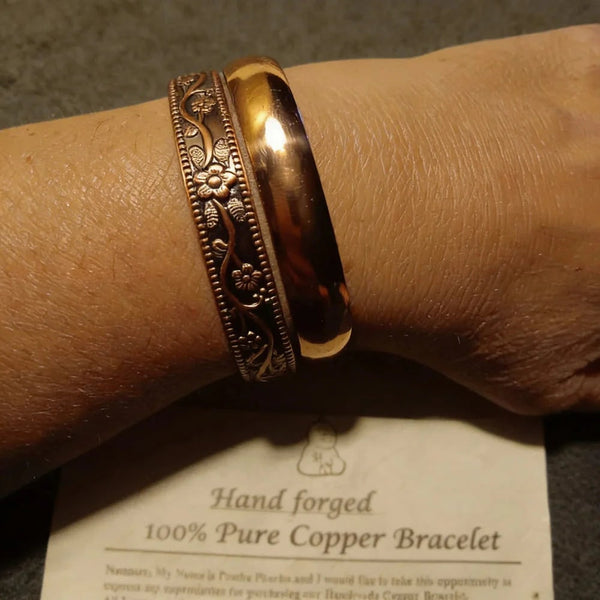 Woman wearing copper floral cuff & bangle