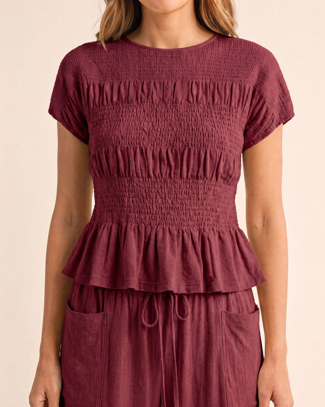 Smocked top and wide-leg pants set in burgundy, close-up of the smocked top