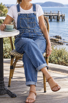 Classic denim overalls in blue at a seaside cafe