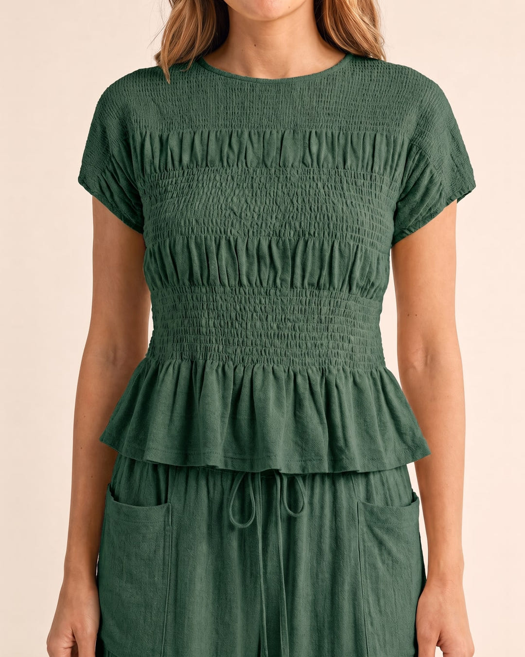 Smocked top and wide-leg pants set in sage, close-up of the smocked top