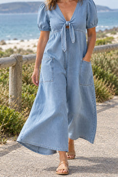Tie-front wide-leg jumpsuit in light blue on a coastal walk