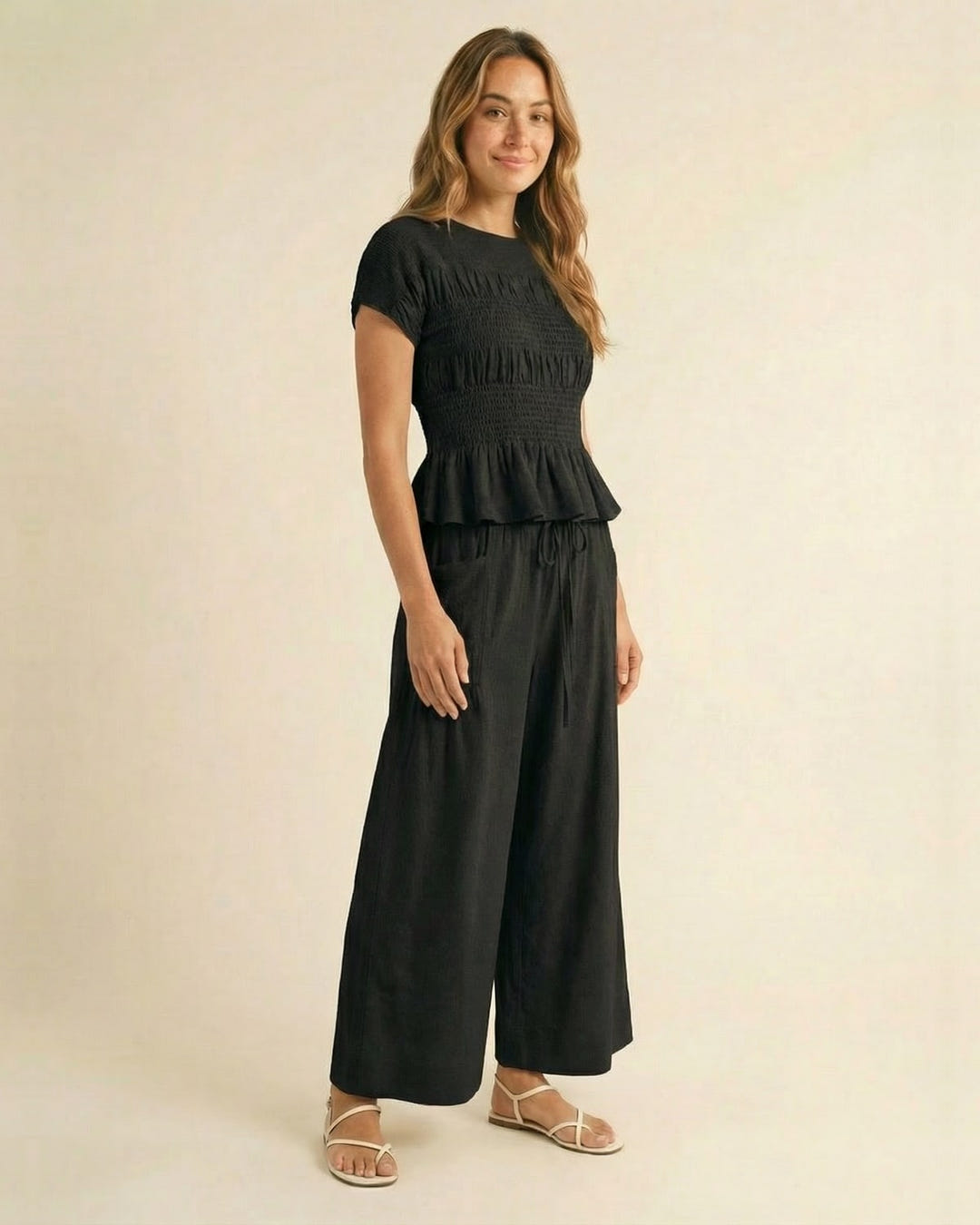 Smocked top and wide-leg pants set in black, walking