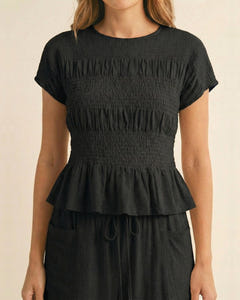 Smocked top and wide-leg pants set in black, close-up of the smocked top
