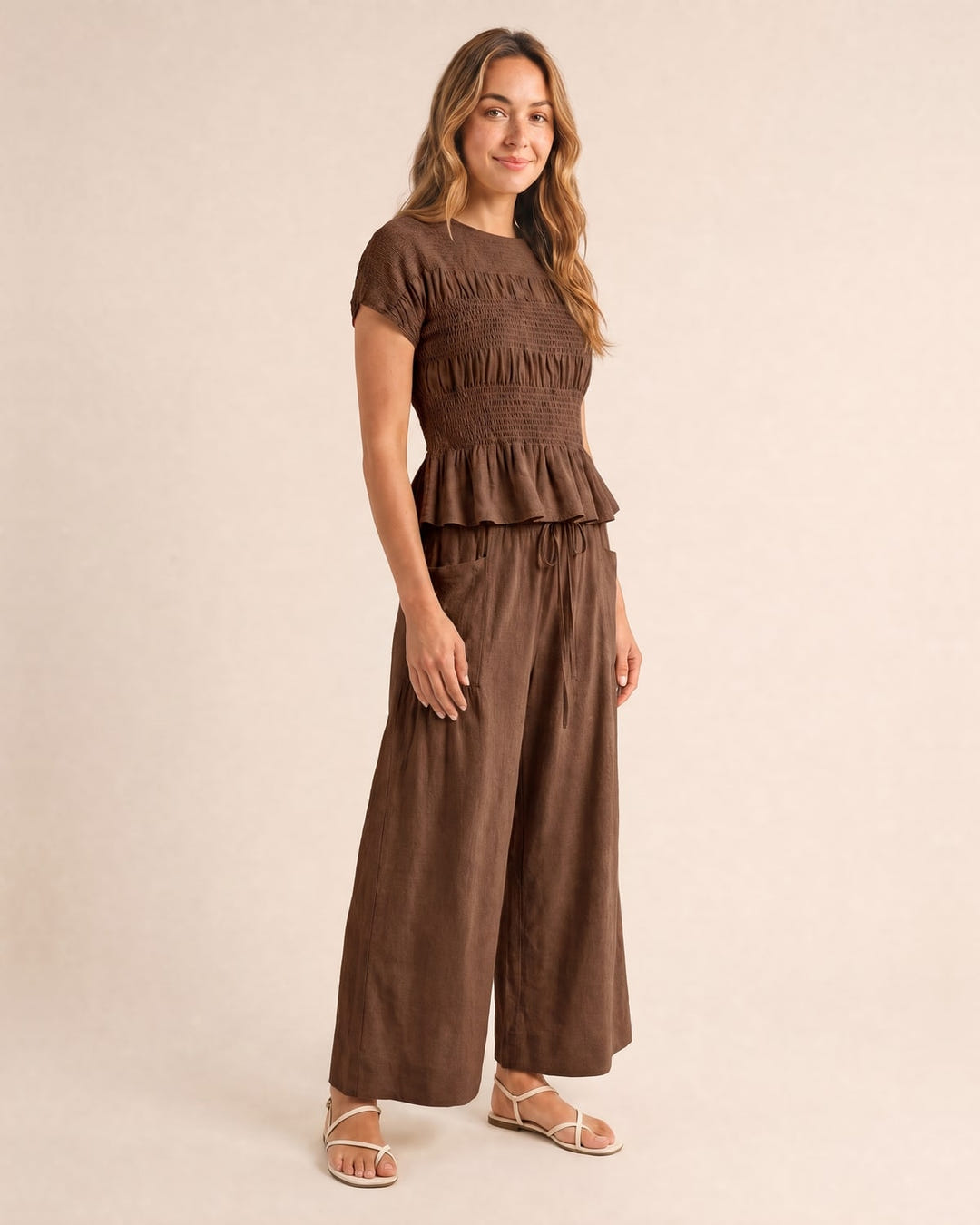 Smocked top and wide-leg pants set in brown, walking