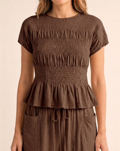 Smocked top and wide-leg pants set in brown, close-up of the smocked top