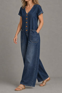 Short-sleeve denim jumpsuit in dark blue from the side, wide legs