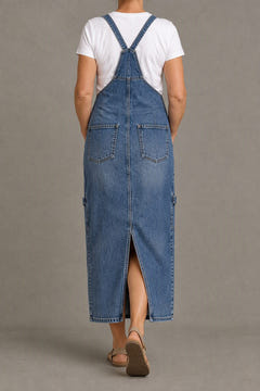 Back-slit denim overall dress from the back, straps crossed