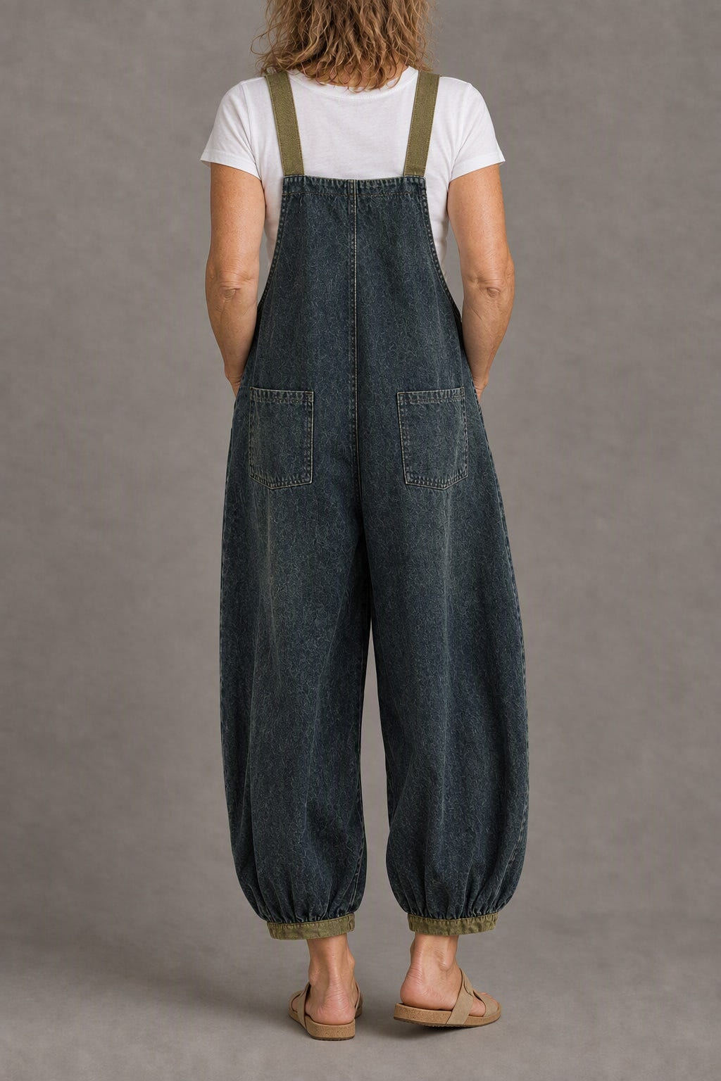 Balloon-leg denim overalls from the back, khaki straps and two back pockets